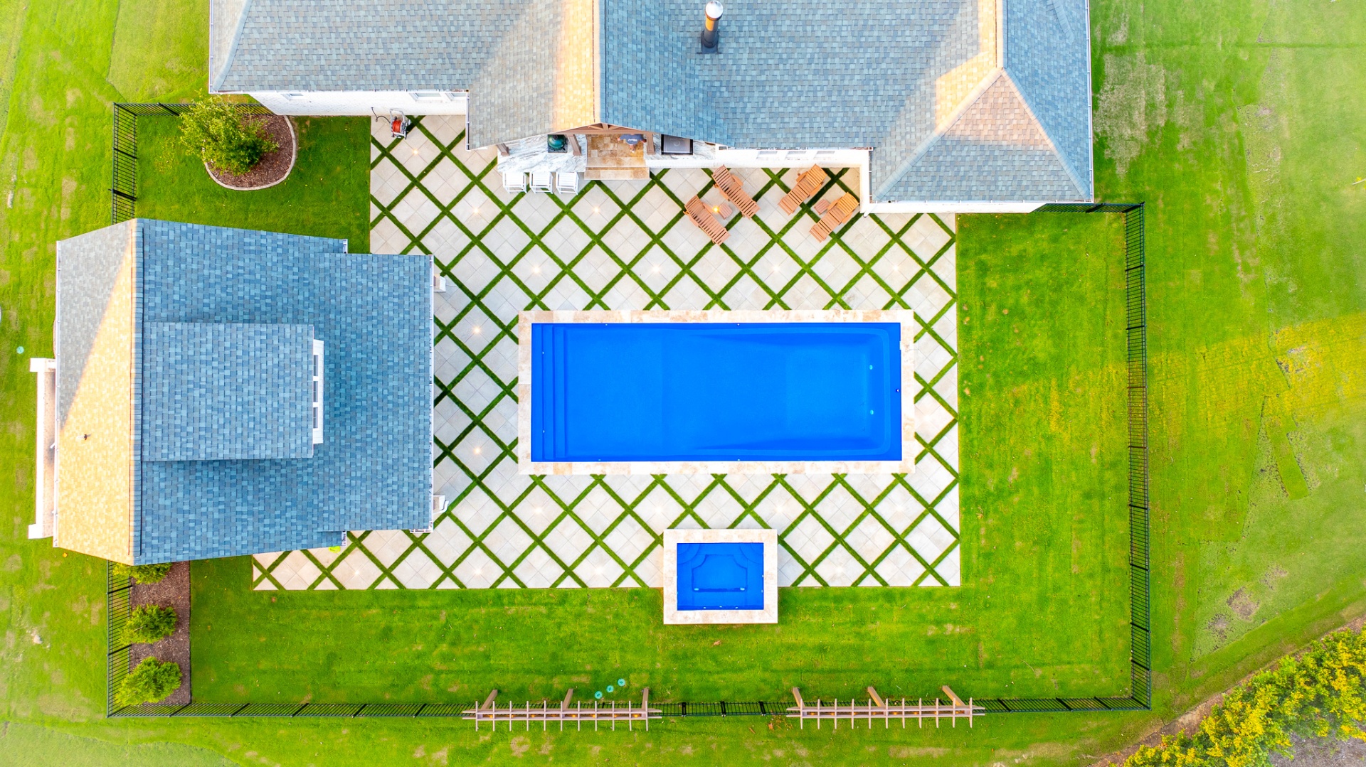 Aerial view of rectangular pool with paver-and-grass grid deck